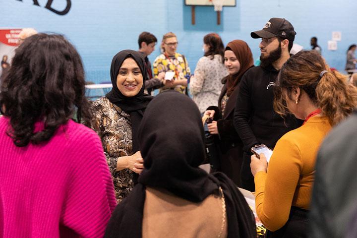 A group of students talking in a group at Fresher's Fayre.