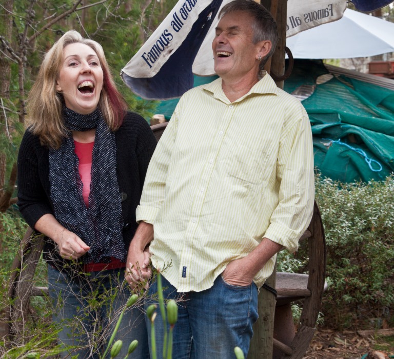 Two people stood outside smiling and laughing