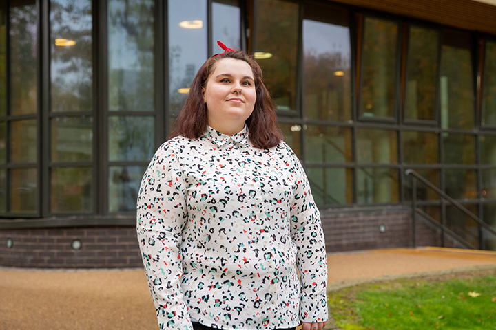 A student smiling at the camera