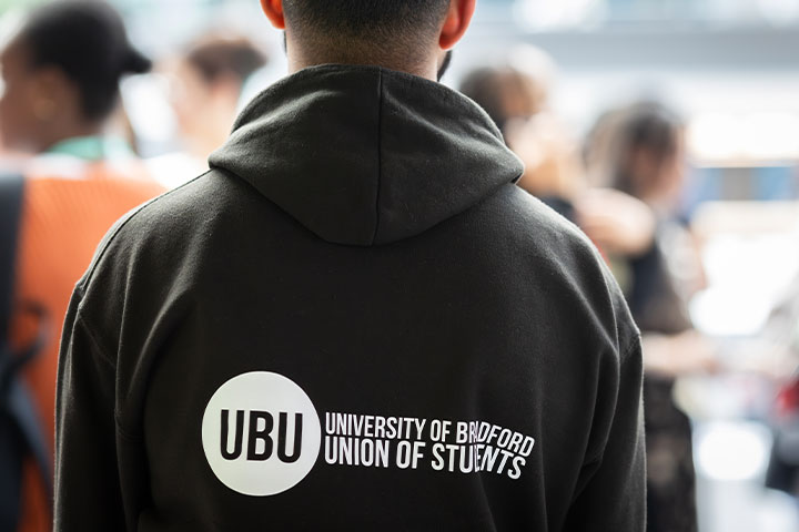 The back of a person wearing a UBU hoodie.