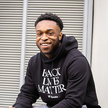 A student smiling at the camera.