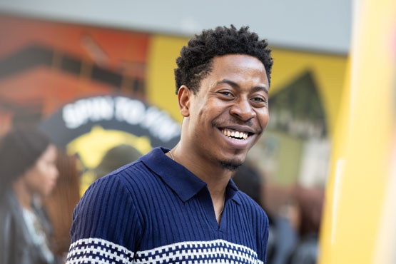 A student smiling at the camera