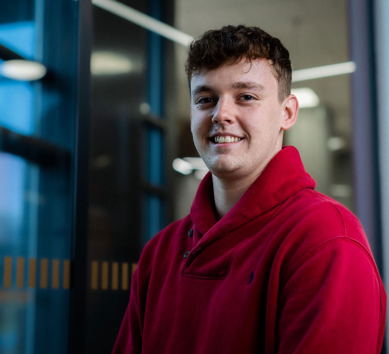 A student smiling at the camera