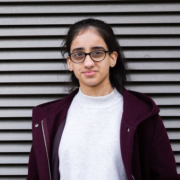 A student smiling at the camera