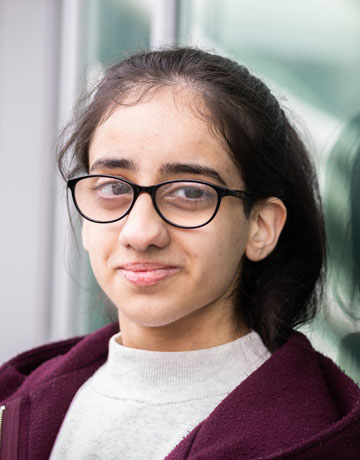 A student smiling at the camera