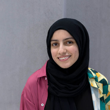 A student smiling at the camera