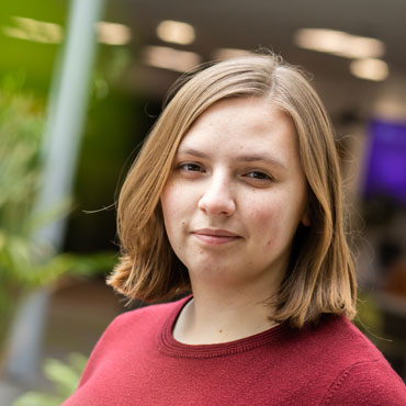 A student looking at the camera with a slight smile