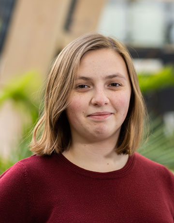 A student smiling at the camera