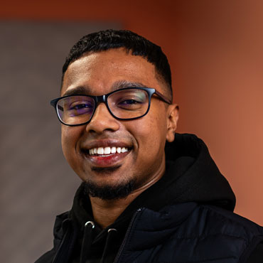 A student smiling at the camera