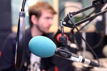 A student recording audio into a microphone