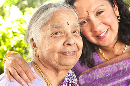 Young and older person smiling.