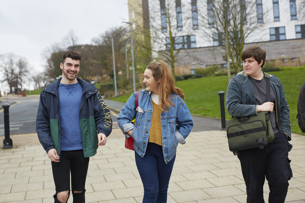 Three students walking through The Green together.