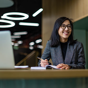 A student smiling and looking away from the camera.