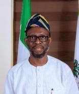 Prof Olanrewaju standing in office posing for picture