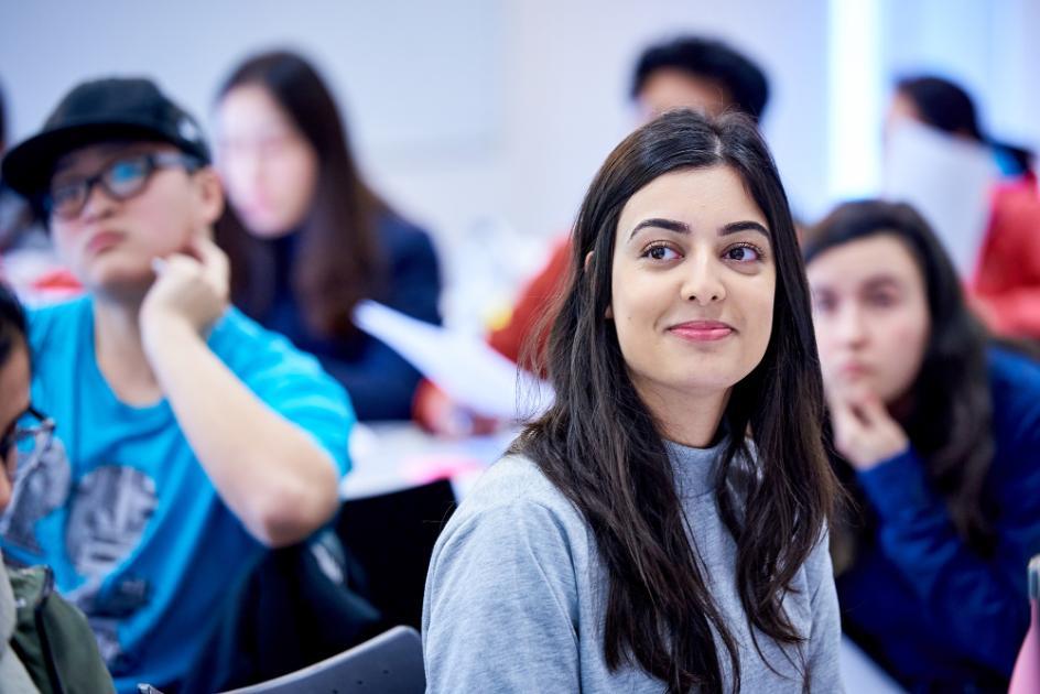 A smiling student listens to a Career Booster presentation