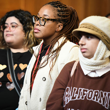 Three students looking to the left.