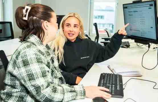 Two students sat down in front of a computer