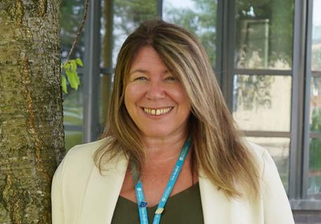 A profile picture of Dr Joanna Nichols outside by a tree in landscape format