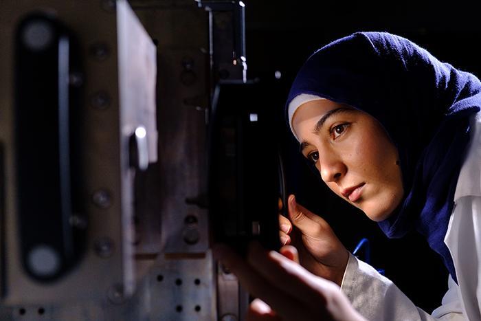 A scientist at Polymer IRC examines some equipment