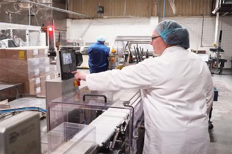 A factory worker operating machinery in Rakusens, Leeds