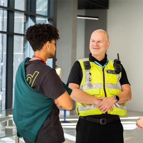 University security officer speaking to a student in the Richmond entrance