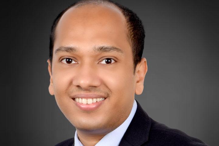 Head shot of a person smiling at the camera.