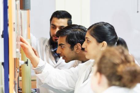 Students looking at a wall.