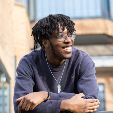 Student wearing glasses and smiling