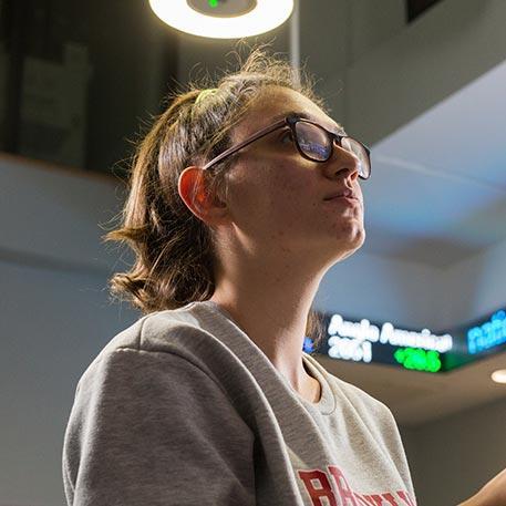 A student looking away from the camera in the Bloomsberg room.