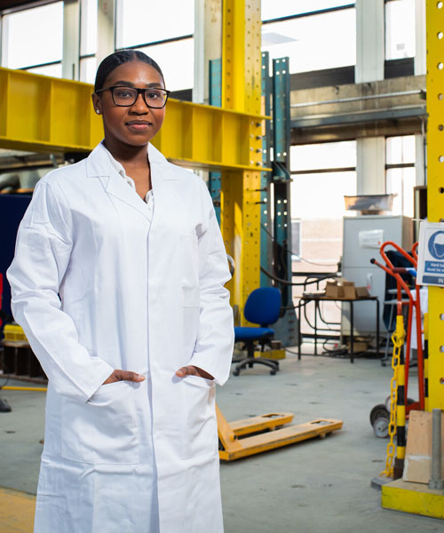 A student standing in a engineering workshop