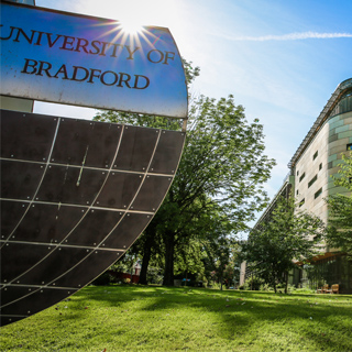 'The University of Bradford' printed on a statue in front of the Health Studies building.